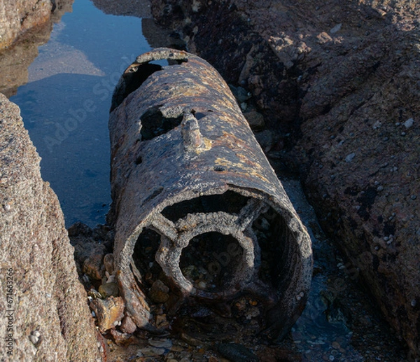 Obraz November 2022, the remains of a shell in rear view, dating from the Second World War in the reefs of the beach of La Sauzaie, Vendée FRANCE.