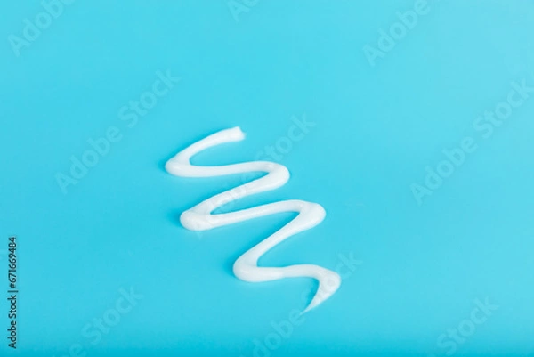 Fototapeta Sunscreen on an orange background. SPF cream. Sun protection. UV protection. Summer. The concept of rest and vacation. Summer mood. Design. MOCKUP. Shopping concept.