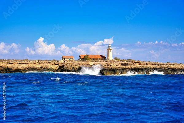 Fototapeta View from the sea towards the lighthouse on the island.
