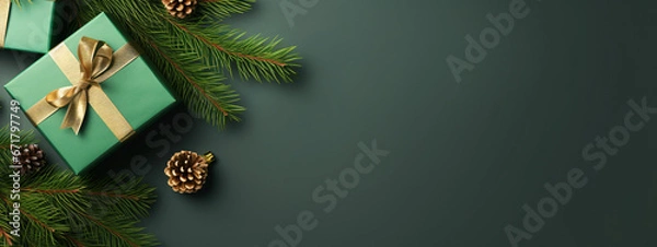 Fototapeta Christmas background design concept, holiday decoration ornament composition with Christmas tree branch, gift box with copy space isolated on green table.