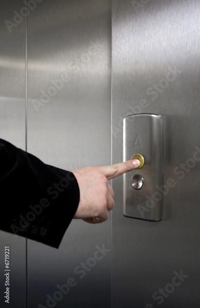 Fototapeta Man pressing elevator button