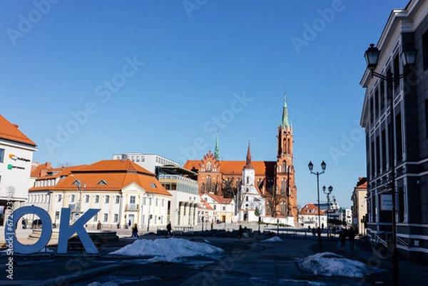 Fototapeta A beautiful square with historical buildings on a sunny day. Kosciuszko Market Square in Bialystok, Poland, March 3, 2021