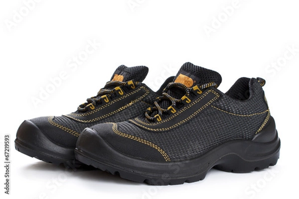 Fototapeta Black working boots with yellow thread on white
