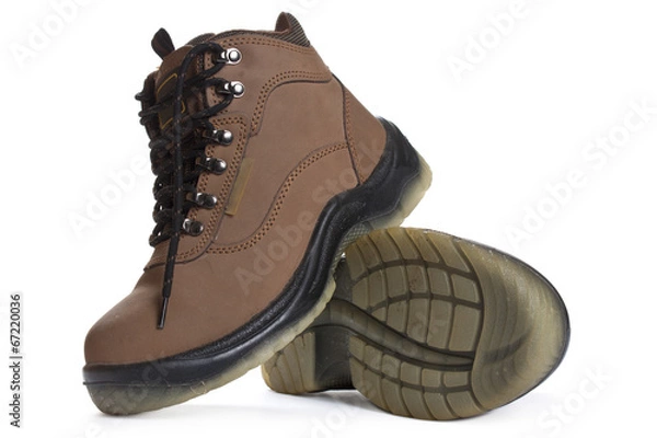 Obraz New brown working boots on a white background.