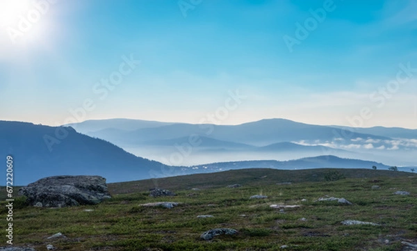 Obraz Early in the morning up in the mountains of Tänndalen in Sweden. A beautiful blue sky and morning mist still lingering down in the valley.