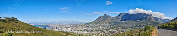 Fototapeta Wide angle of Cape Town and mountain landscape on a sunny day. Beautiful view of a city against a blue horizon. A popular travel destination for tourists and hikers, on Table Mountain, South Africa