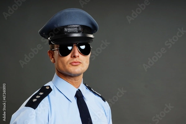 Fototapeta Portrait of policeman in uniform in sunglasses