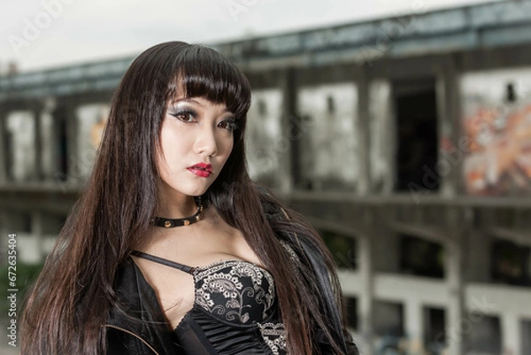Obraz Asian woman in emo goth clothes at an abandoned building