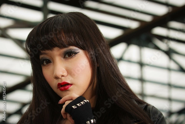 Obraz Asian woman in emo goth clothes at an abandoned building
