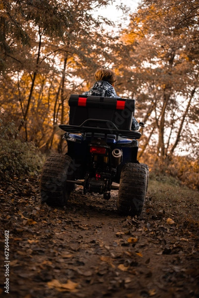 Fototapeta A trip on the ATV on the red road.