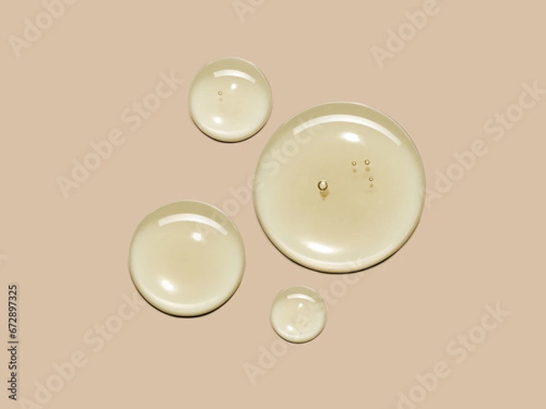 Fototapeta Yellow serum oil sample swatch round shape texture isolated on beige background. cosmetic Hyaluronic acid retinol collagen science lab product