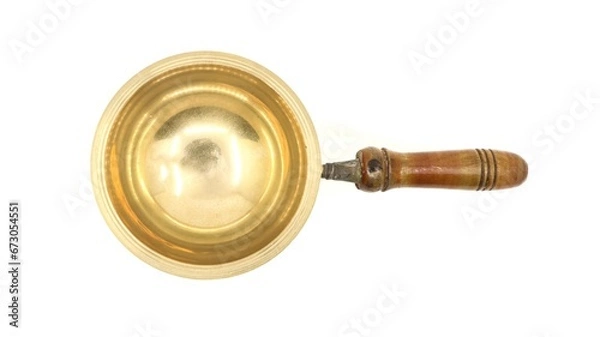 Fototapeta top view of a vintage golden brass diya oil lamp or vilakku with handle traditionally used for pooja rituals in temples of india isolated in a white background