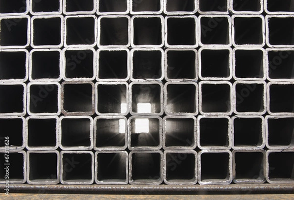 Fototapeta stack​ of square​ metal tubes​ profile or pipes for construction supplies and welding works. Industry background