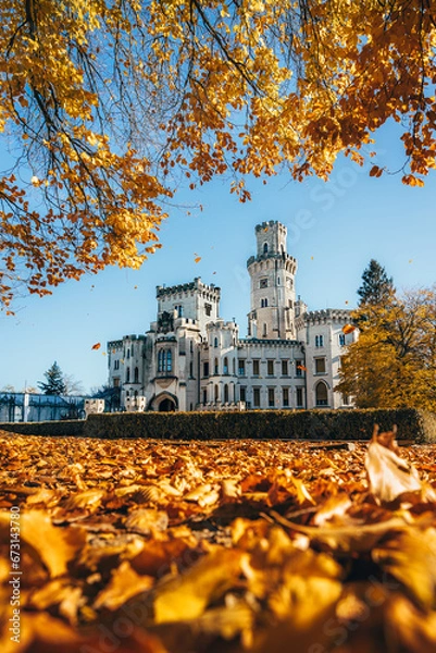 Obraz Chateau Hluboká. View from the outdoor garden in autumn with blue sky and falling leaves