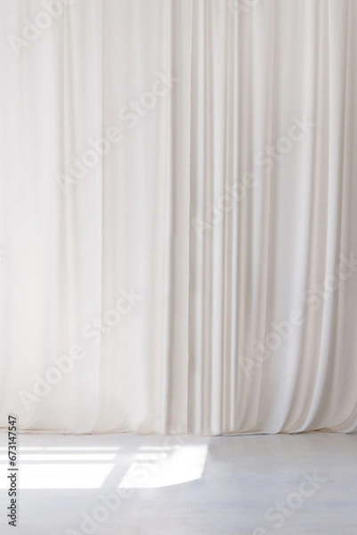 Fototapeta White curtain that dropped down as a straight line. White wooden floor. Background for inserting text, empty spaces.