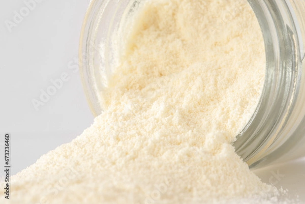 Fototapeta Colostrum Powder Spilled from a Jar
