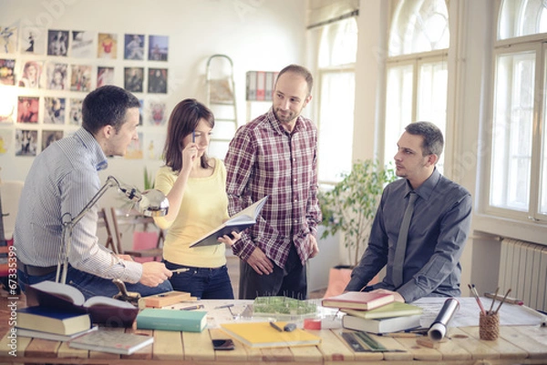 Fototapeta Group of Architects with teacher working at project