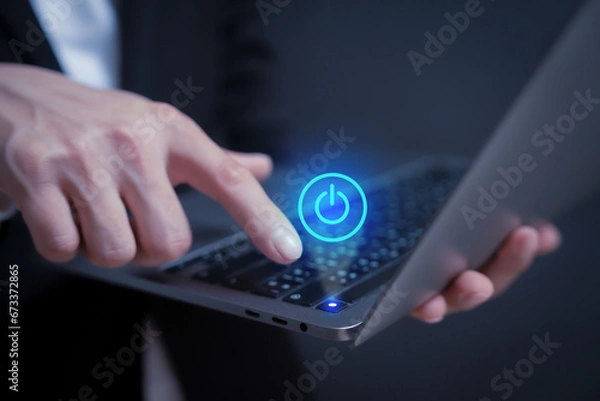 Fototapeta turn on laptop or program by a person pressing the turn off or on button in holographic to access data and manage by business style 