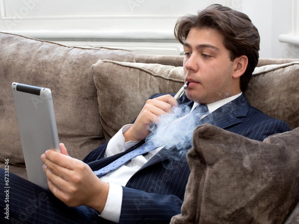 Obraz Young man relaxing with an e-cigarette