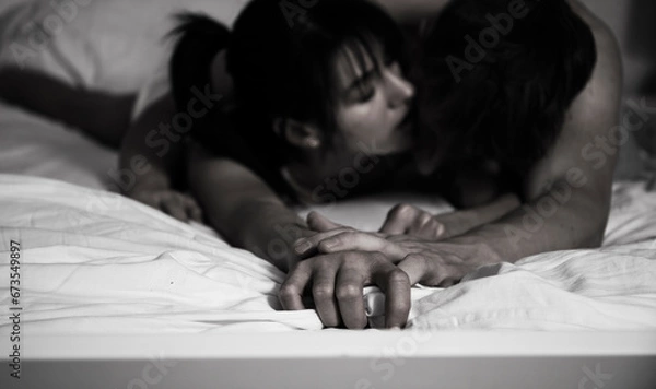 Obraz Shot of a happy young couple relaxing in bed together at home.
