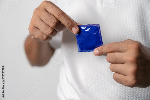 Fototapeta Condom ready to use in hands