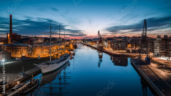 Fototapeta Aerial view of calm aurajoki river and Swan of Finland sailing ship at dawn in Turku, Finland