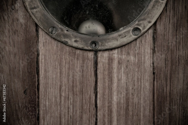 Fototapeta Close-up of a wooden boat closed porthole