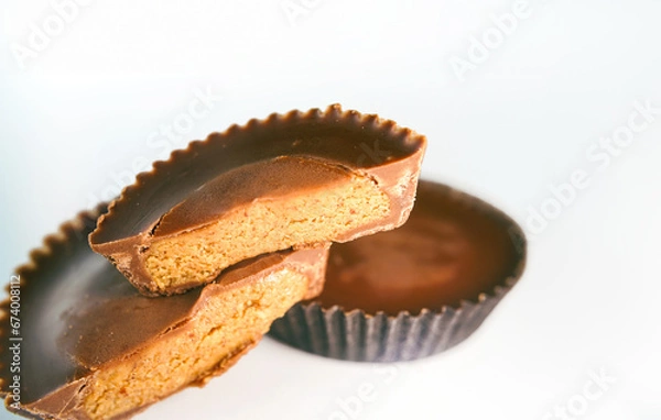 Fototapeta Macro shot of Peanut butter filled candy with chocolate frosting isolated on white background