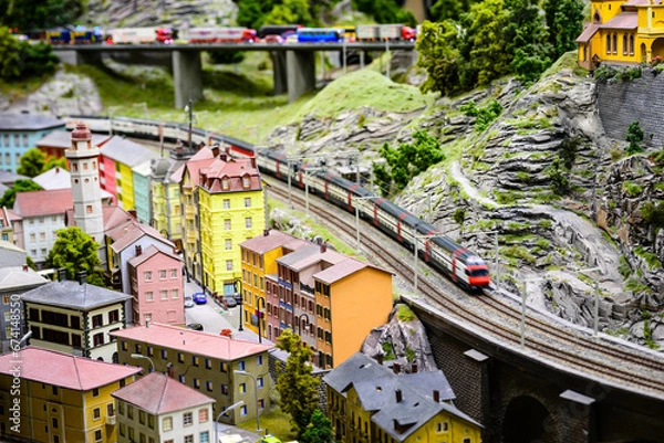 Obraz view of the train coming around the mountain in a model railway of alpine village