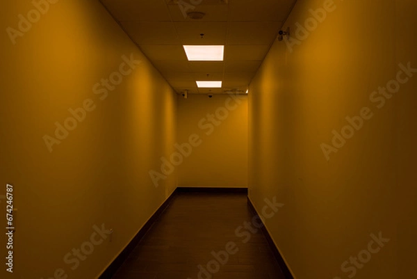Fototapeta Empty hallway - dimly lit - orange glow - fluorescent light