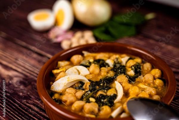 Obraz Delicious and traditional dish of chickpea stew with spinach and egg