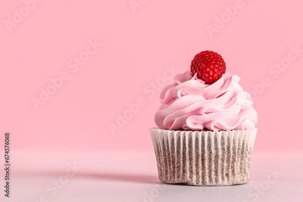 Fototapeta Tasty raspberry cupcake on pink background