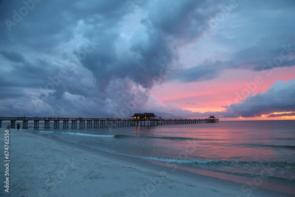 Obraz The Naples Beach pier at sunset and during a rough thunderstorm