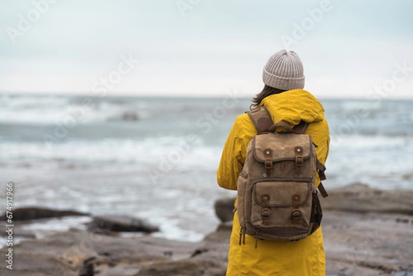 Obraz Beautiful woman traveler enjoying autumn hiking at the seaside. Active lifestyle