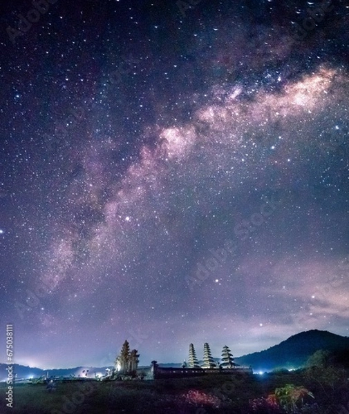 Fototapeta AI generated illustration of the Tamblingan Lake Temple in Munduk, Bali, under the starry night sky