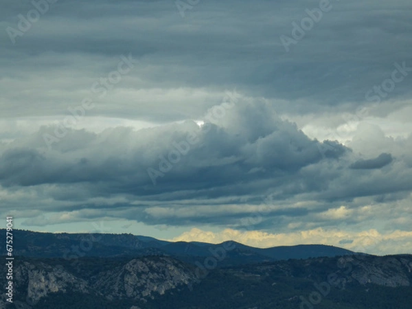 Fototapeta Stormy skies with threatening gray clouds hanging over the Luberon mountains in Provence in France 