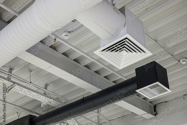 Fototapeta Two ventilation duct systems with grilles under ceiling in commercial building. Supply and exhaust