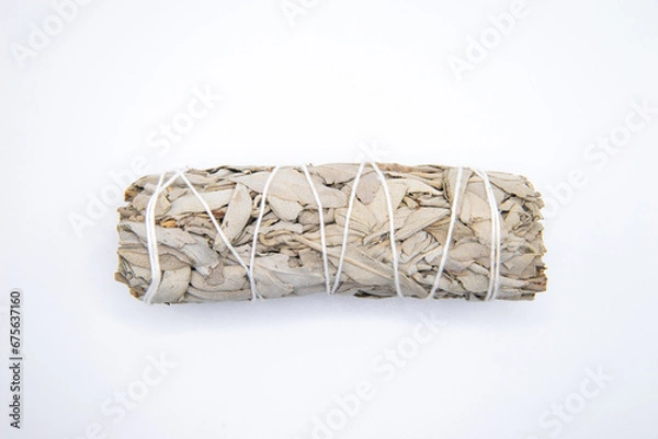 Fototapeta Bundle of dry white sage close-up isolated on white background. Normally used for purification, meditation and healing