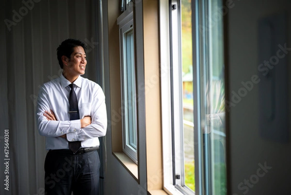 Fototapeta 窓の外を見るビジネスマン