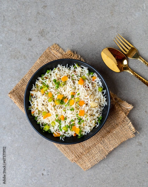 Fototapeta Authentic Chinese and Asian fried rice with egg and vegetables in ceramic brown bowl top view .Traditional dish of China with space for text.