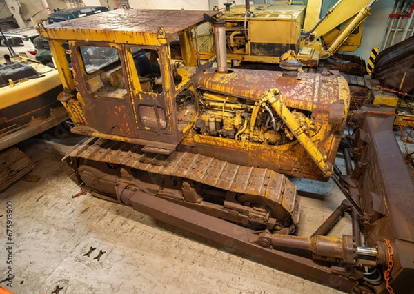 Fototapeta rusty bulldozer loader heavy machinery inside a ship