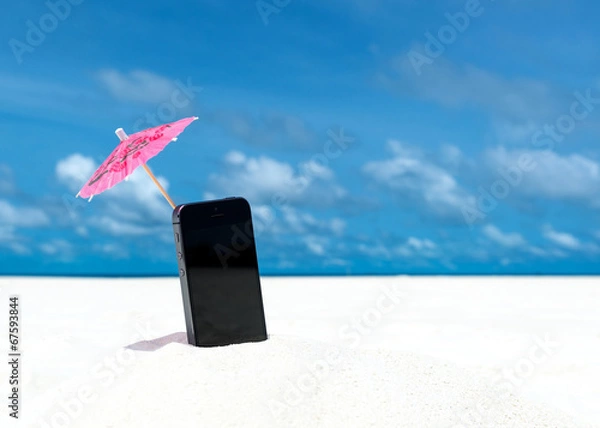 Obraz Mobile phone and cocktail umbrella on the beach