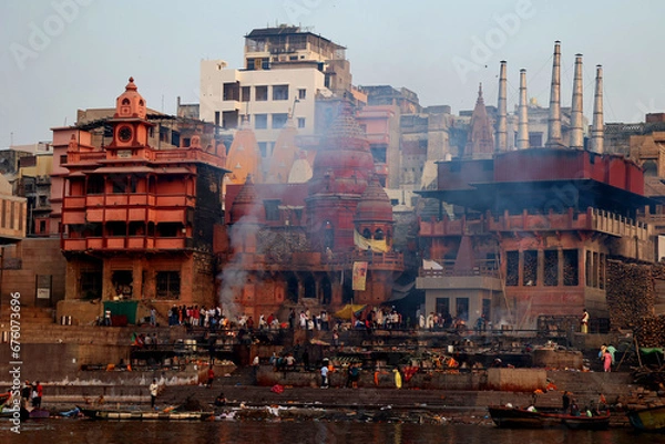 Obraz View of the ceremony of the cremation of a unknown Hindu person at Manikarnika Ghat front the Ganges river in Varanasi India