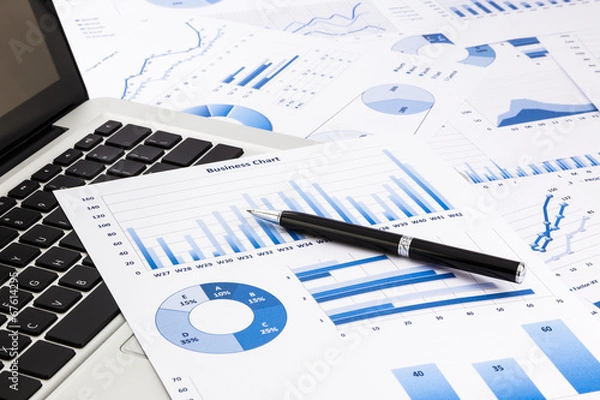 Obraz laptop and pen with blue business charts, graphs, statistic and