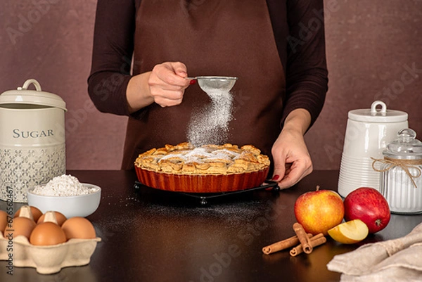 Fototapeta Food photography of apple pie cooking, american dessert; sugar powder, icing, pour, cinnamon; confectionery; bakery; baking; pastry