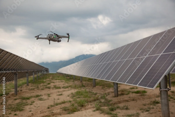 Fototapeta Drone next to solar panels during inspection
