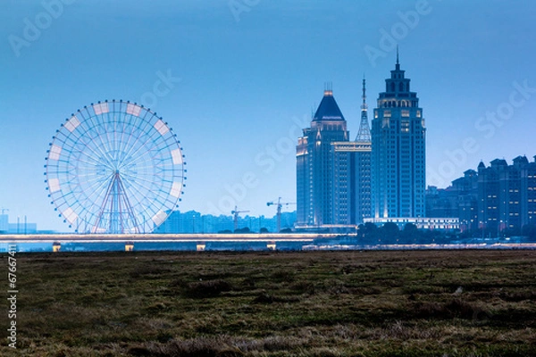 Obraz The city at night and ferris wheel
