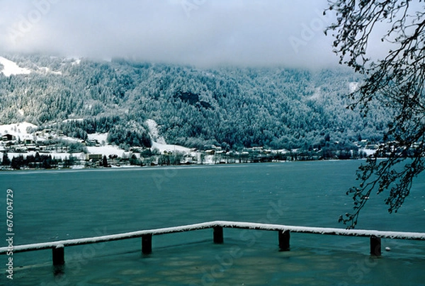 Obraz view across the partly frozen Ossiacher lake on a dull winter day in Carinthia, Austria