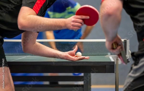Fototapeta Table tennis player serving in a table tennis championship match