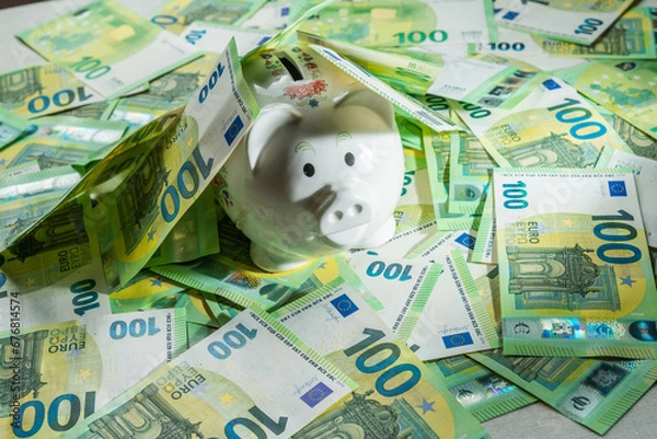 Obraz Money pig on the background of money bills of 100 euros, piggy bank covered with euro bills